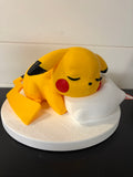 Sleepy Pikachu on pillow and stand