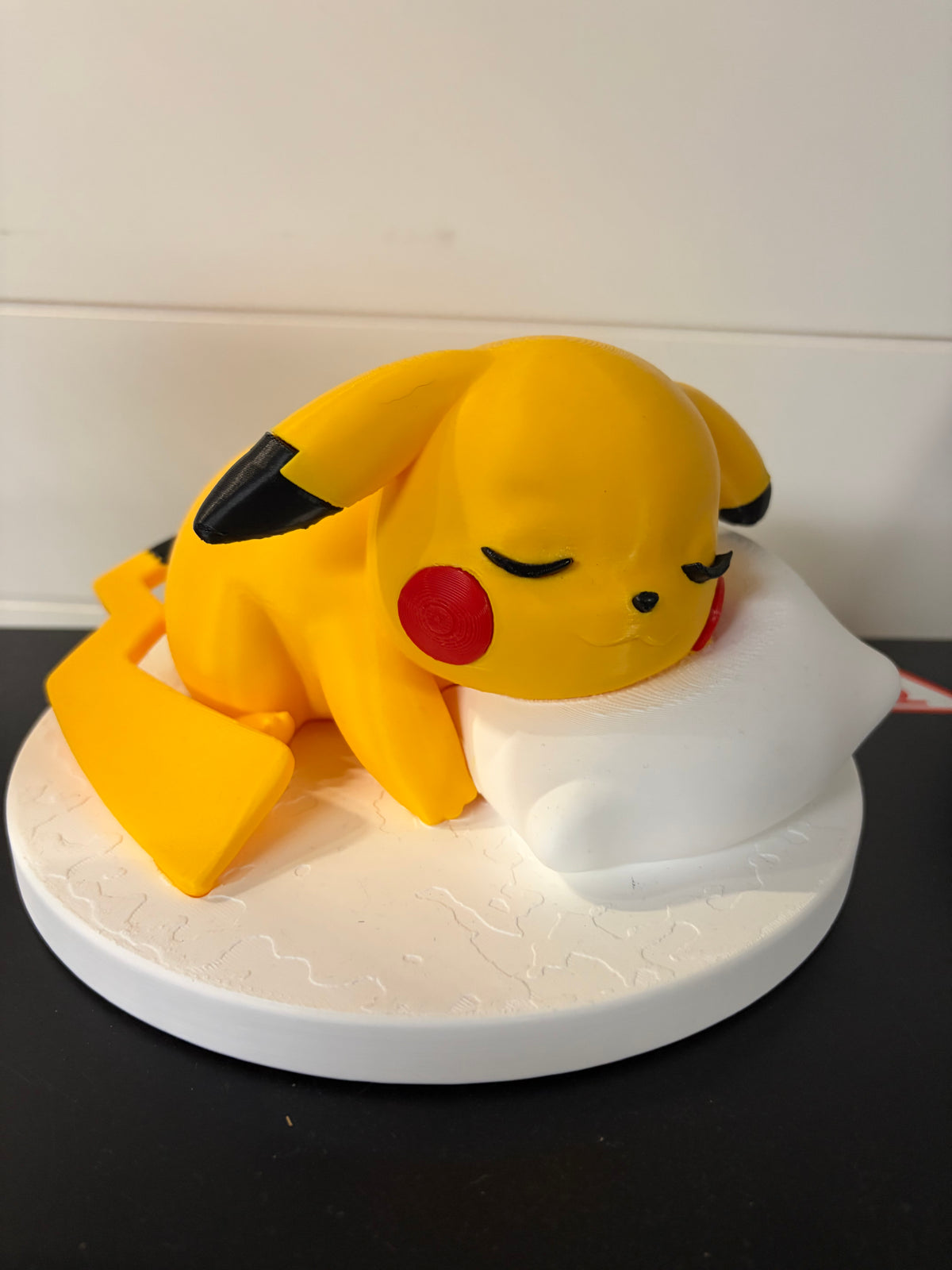 Sleepy Pikachu on pillow and stand