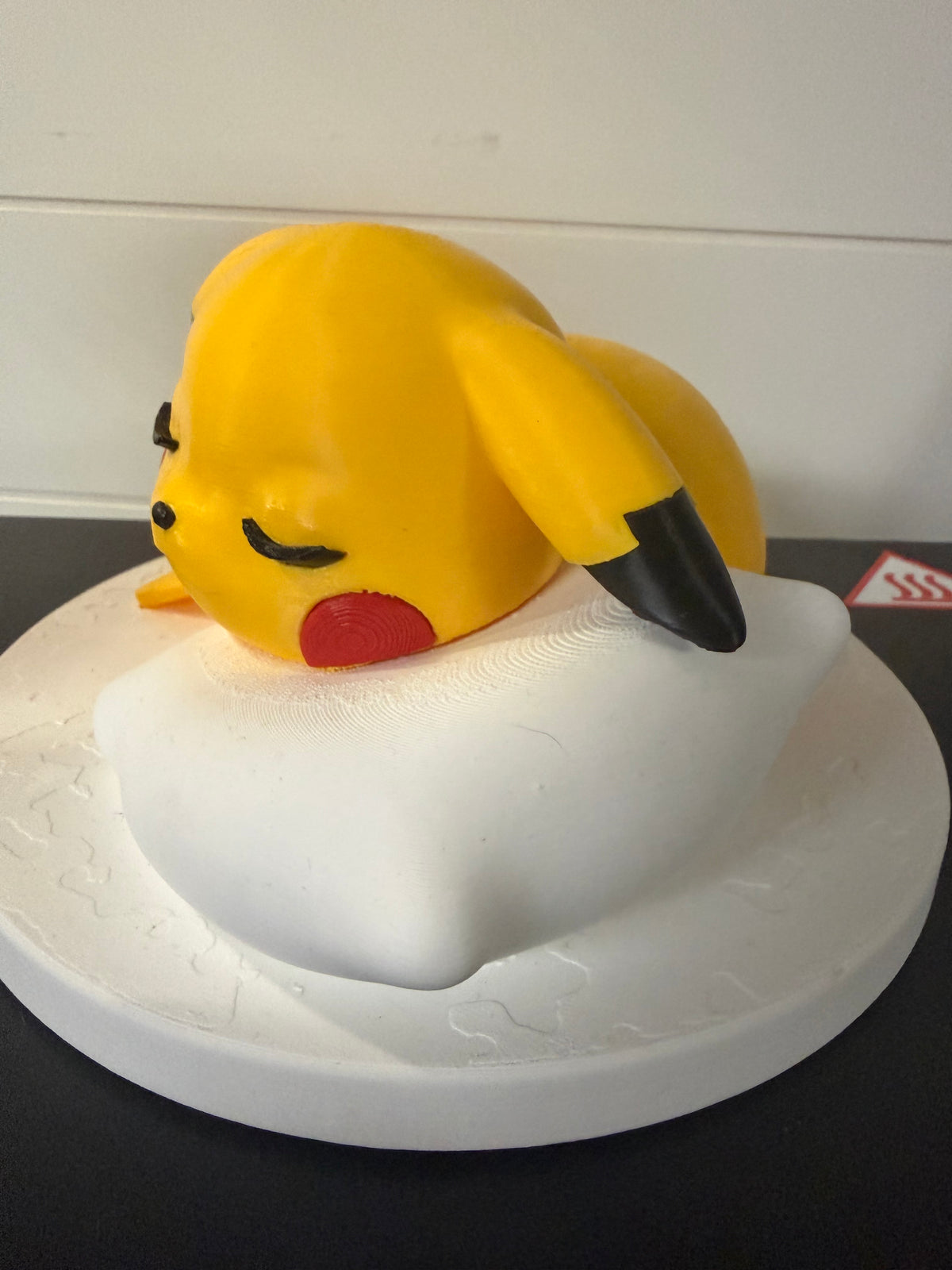 Sleepy Pikachu on pillow and stand
