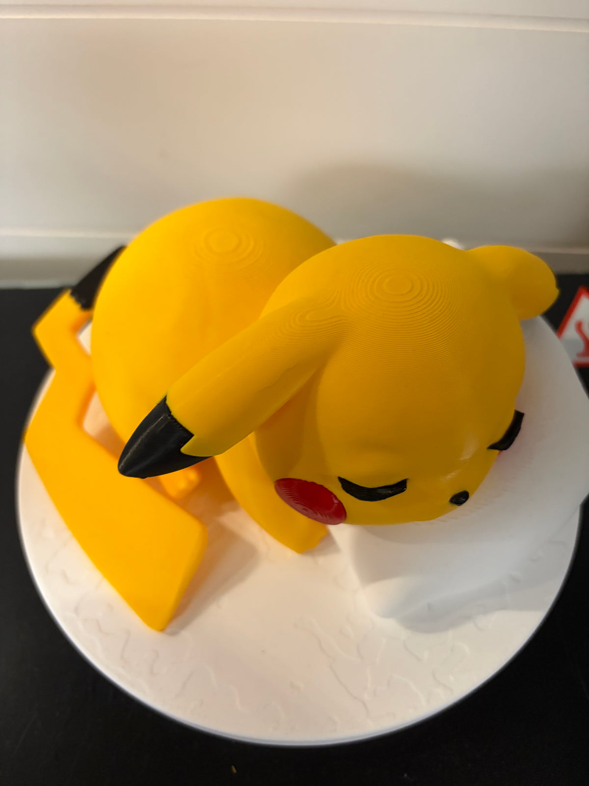 Sleepy Pikachu on pillow and stand
