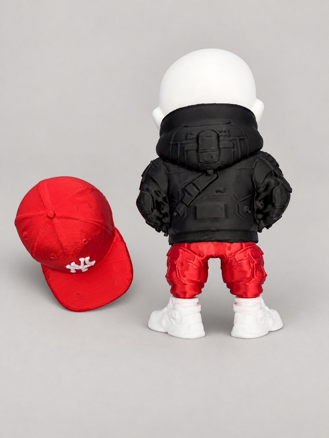 Rear view of Bronx Bones skull figure with detached red New York Yankees cap
