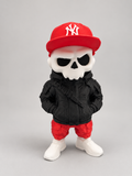 Skull figure wearing a removable red New York Yankees cap, black jacket, red pants and white boots