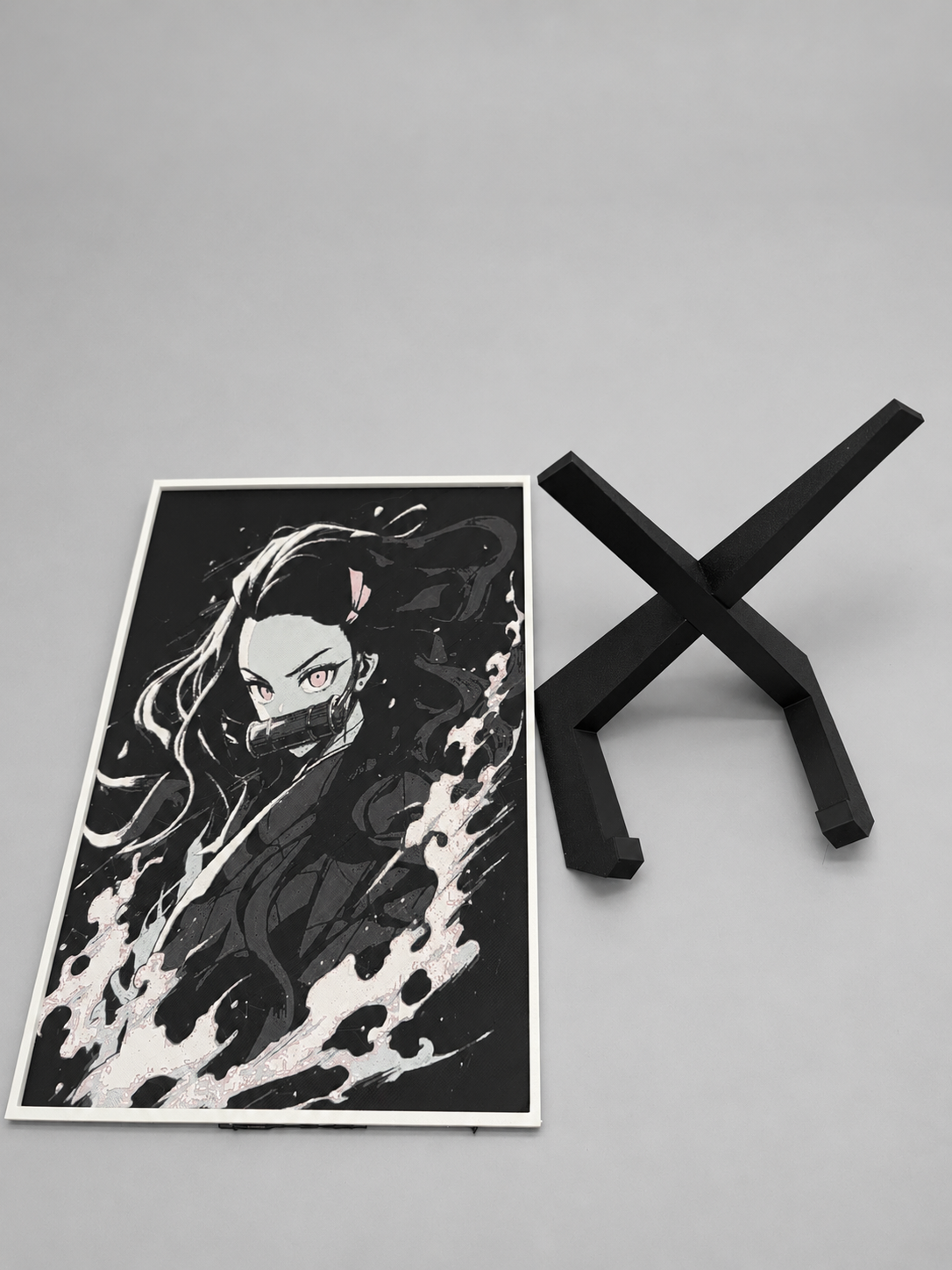 Nezuko artwork beside black display stand
