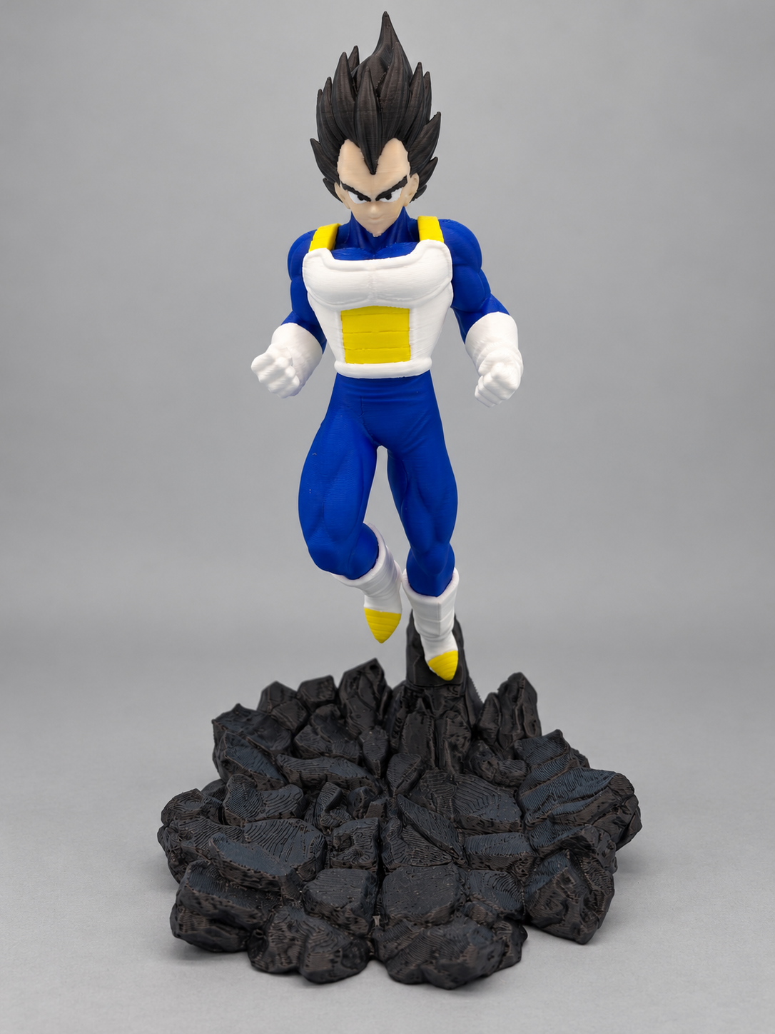 Vegeta figure front view on black rocky base