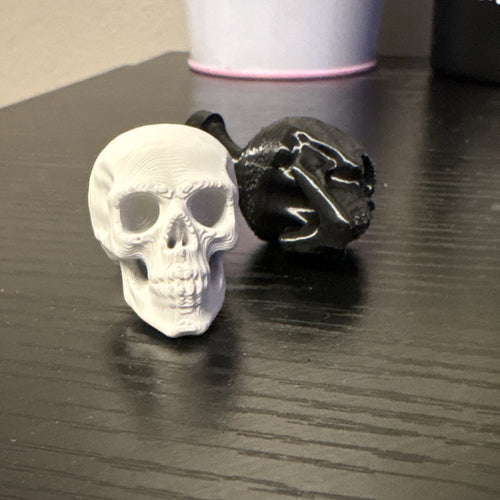 Black or light grey Skull knobs/cabinet pulls.